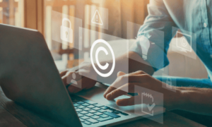 Man working on laptop in danger of exposure to Intellectual Property Infringement